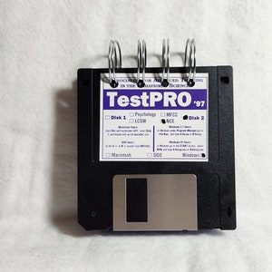 May include: A black floppy disk with a silver metal insert. The disk is labeled "TestPRO '97" and has checkboxes for "Psychology", "LCSW", "MFCC", "NCE", "Macintosh", "DOS", and "Windows".