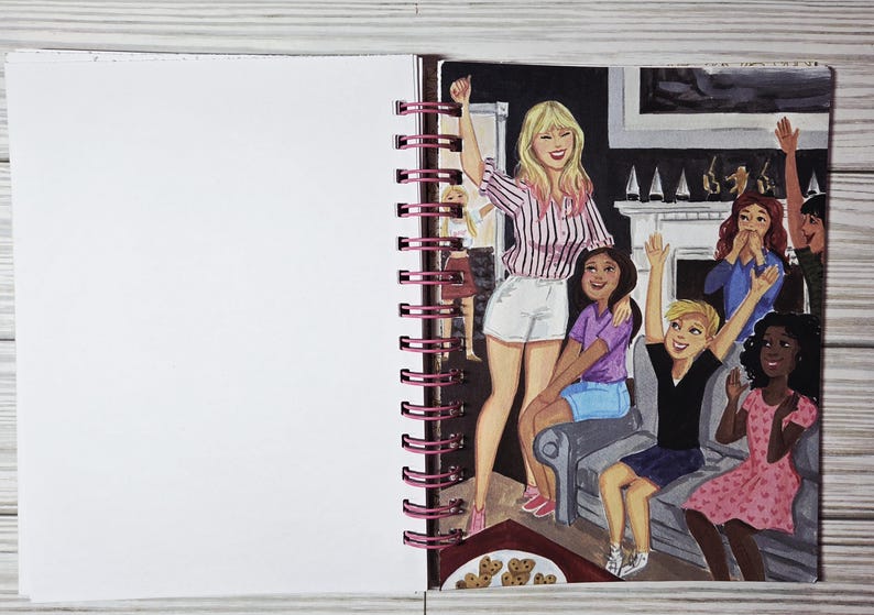 May include: An illustration in a spiral-bound notebook depicts a group of people celebrating. A woman in a pink striped shirt and white shorts stands with her arm raised. Other figures are seated and standing, with arms raised in celebration. A plate of cookies is in the foreground.