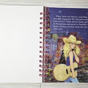 May include: A spiral-bound notebook open to two pages. The right page features an illustration of a woman with blonde hair wearing a cowboy hat and holding a guitar. Text on the page describes a country music star's dream.