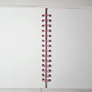 May include: Open blank notebook with white pages and a pink spiral binding. The notebook is lying open on a light gray wooden surface. The pages are clean and ready for writing or drawing.