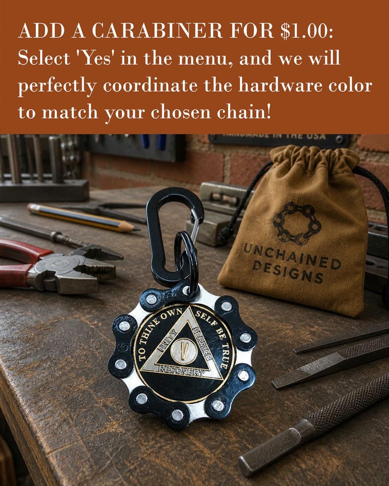 May include: A circular medallion featuring a black and silver bicycle chain outer ring surrounding a central triangle emblem. The emblem displays the text TO THINE OWN SELF BE TRUE, UNITY, SERVICE, RECOVERY, and the Roman numeral V. A black carabiner is attached.