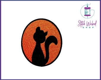 May include: Black cat silhouette on an orange circle with a textured surface. The circle is outlined in black.