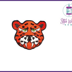 May include: Orange and black embroidered iron-on patch of a cartoon tiger face with a toothy grin.