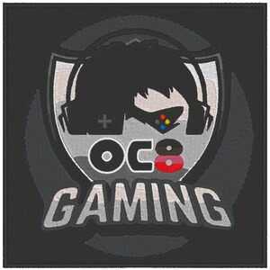 May include: A black and white logo with a stylized image of a person wearing a headset and holding a video game controller. The logo says "OC8 GAMING" in white text.