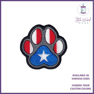May include: An embroidered paw print patch in red, white and blue with a star in the centre. The patch is available in various sizes and custom colours.
