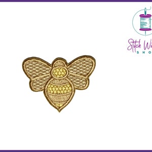 May include: A gold embroidered bee patch with brown wings. The bee has a yellow and gold striped body.