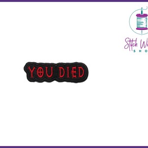 May include: Black embroidered patch with the text "YOU DIED" in red.