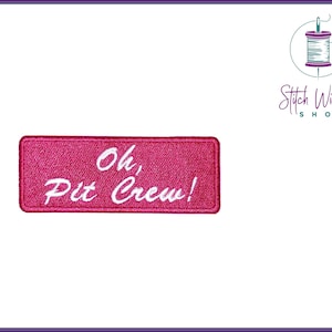 May include: Pink embroidered iron-on patch with white text that reads "Oh, Pit Crew!"
