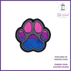 May include: Embroidered paw print patch in bisexual pride colours: pink, purple, and blue. The patch is grey with black stitching around the edges.