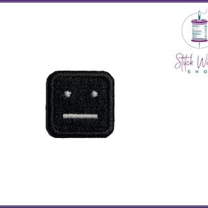 May include: Black square patch with a white embroidered face with two eyes and a straight mouth.
