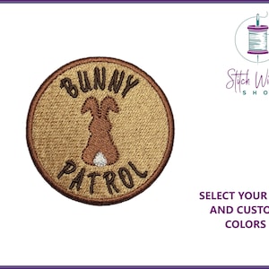 Peut inclure: Patch brodé marron avec une silhouette de lapin et le texte "Bunny Patrol".