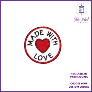 May include: Circular embroidered patch featuring a red heart and the text "MADE WITH LOVE". The patch has a white background and a red border. The text "AVAILABLE IN VARIOUS SIZES" and "CHOOSE YOUR CUSTOM COLORS" are also visible.