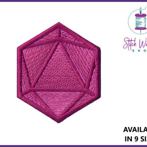 May include: A pink embroidered patch shaped like a twenty-sided die, or d20, a common die used in tabletop role-playing games.