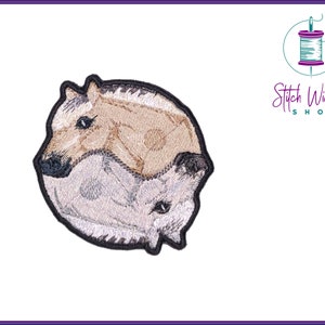 May include: Embroidered patch of two horses facing each other in a yin yang design. The horses are brown and white.