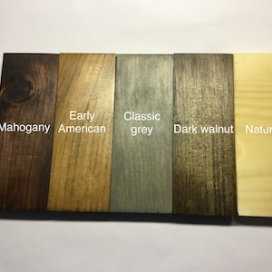 May include: Five wood samples stained in different colors: mahogany, early American, classic grey, dark walnut, and natural.
