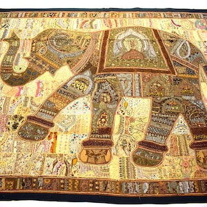 May include: A large tapestry featuring an embroidered elephant in shades of brown, gold, and cream. The elephant is made up of many different fabric patches and is decorated with beads and sequins. The tapestry has a black border.