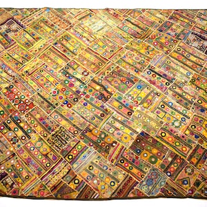 May include: A colorful patchwork quilt with a geometric pattern. The quilt is made of various fabrics and features small round mirrors.