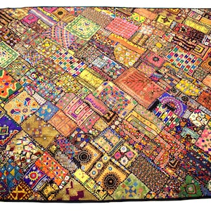 May include: A colorful patchwork quilt with a variety of fabrics and textures. The quilt is made up of many small squares and rectangles, each with a different pattern. The quilt is a vibrant mix of colors, including red, orange, yellow, green, blue, purple, and brown.