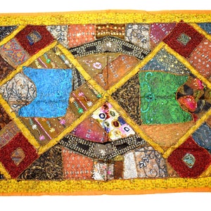 May include: A colourful patchwork quilt with a diamond pattern. The quilt is made of various fabrics in shades of brown, red, blue, green, and gold. The quilt is decorated with sequins and embroidery.
