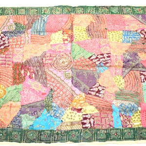 May include: A colorful patchwork quilt with a green border. The quilt is made of various fabrics and patterns, including floral, geometric, and paisley designs. The quilt is decorated with sequins and beads.