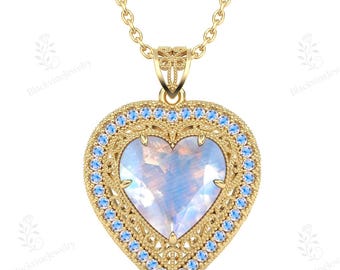 May include: A gold heart-shaped pendant necklace featuring a central iridescent moonstone-like gem. The heart is framed by a decorative gold border set with small light blue stones, suspended from a delicate gold chain on a plain white background.