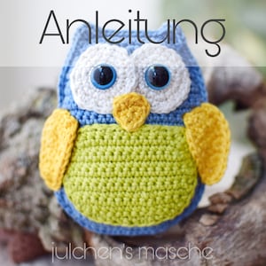 May include: A crocheted owl toy with blue, green, white, and yellow yarn. The owl has large black eyes and a small orange beak. The text "Anleitung" is above the owl.