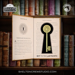 May include: An open book with the title "Key to the Labyrinth" and a gold-coloured key-shaped pendant. The book's pages feature text and illustrations, with a background of a bookshelf.