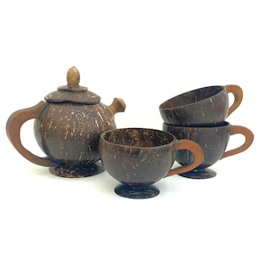 May include: A coconut shell tea set, comprising a teapot with lid and four teacups. The tea set has a natural brown colour and a textured finish. The teacups have wooden handles. A unique and eco-friendly tea set.