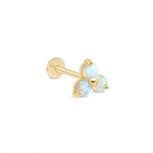 May include: A gold stud earring with three opalescent gemstones. The earring has a flat, circular back and a straight post. The gemstones are arranged in a cluster, creating a floral or star-like design. The gemstones are round.