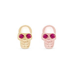 May include: Two gold skull earrings with pink gem eyes. The skull on the left is yellow gold and the skull on the right is rose gold.