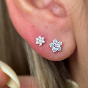 a close up of a person wearing a pair of ear piercings