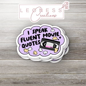 May include: Purple sticker with a white cloud shape and the text "I speak fluent movie quotes" with a black VHS tape and popcorn inside the cloud.