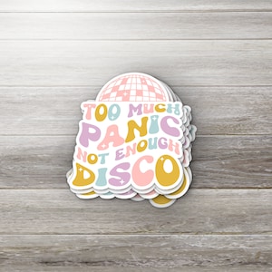 May include: A stack of colorful stickers with a disco ball and the text "Too Much Panic Not Enough Disco".