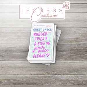May include: A stack of light blue and white guest checks with a pink and white design. The text on the check reads "GUEST CHECK", "BURGER", "FRIES &", "A SIDE of", "inner peace", "PLEASE".