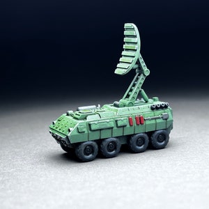 May include: A green military vehicle with a radar dish on top. The vehicle has six wheels and is painted in a camouflage pattern.
