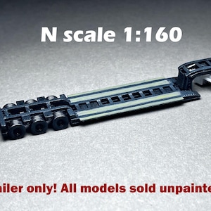 May include: N scale 1:160 black and gray trailer with a flatbed and wheels. Trailer only! All models sold unpainted.