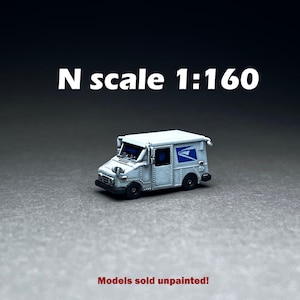 May include: A white, N scale, 1:160 scale model of a United States Postal Service mail truck. The model is unpainted.