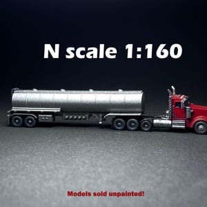 May include: A red and silver model truck and trailer in N scale 1:160. The trailer is a tanker with a silver finish. Models sold unpainted.