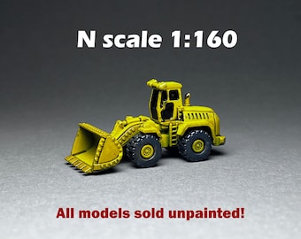 May include: A yellow toy model of a front-end loader in N scale 1:160. All models sold unpainted.