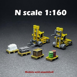 May include: Two yellow toy forklifts in N scale 1:160, with a variety of cargo and pallets. Models sold unpainted.