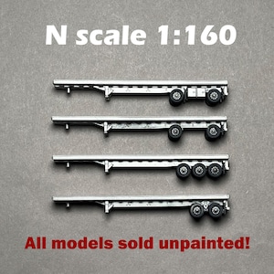 May include: Four unpainted N scale 1:160 model trailer chassis. Each trailer has a silver frame and black wheels. The text "All models sold unpainted!" is in red.