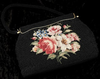 May include: A black beaded evening bag with a floral design featuring pink, white, and blue flowers. The bag has a gold clasp and a beaded handle.