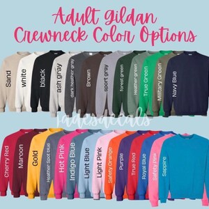 May include: A variety of Gildan crewneck sweatshirt colors, including sand, white, black, ash gray, dark heather gray, brown, sport gray, forest green, heather green, true green, military green, navy blue, cherry red, maroon, gold, heather spot blue, hot pink, indigo blue, light blue, light pink, safety orange, purple, true red, royal blue, safety pink, and sapphire.
