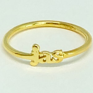 May include: A gold ring with the word "F.A.T.S." spelled out in a stylised font.