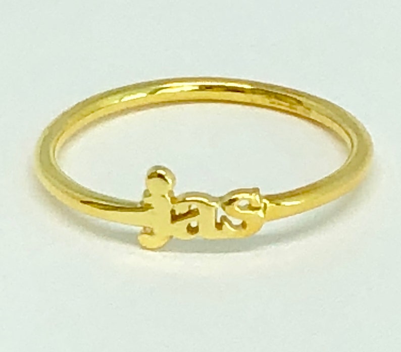 May include: A gold ring with the word "F.A.T.S." spelled out in a stylised font.