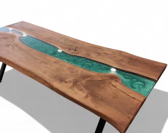 May include: A long, wooden dining table with a live edge and a green epoxy river running down the center. The table has black metal legs.