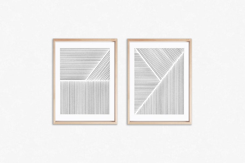 May include: Two framed black and white abstract line art prints with a geometric design. The prints are in simple wooden frames.