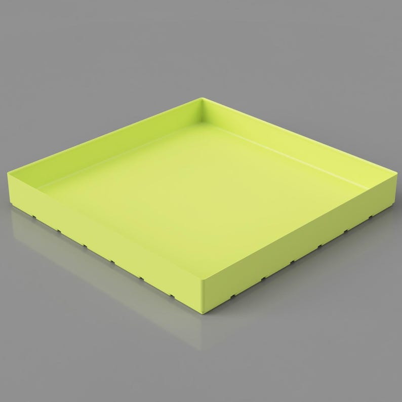 May include: A square, lime green tray with a raised edge. The tray has a smooth, matte finish and is set against a gray background. The sides of the tray have small, evenly spaced holes.