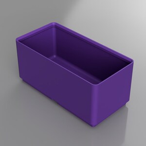 May include: A rectangular, purple container with rounded corners. The container is empty and sits on a gray surface. The sides are smooth and the color is a solid, vibrant purple.