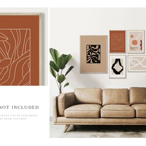 May include: Five abstract art prints in a minimalist style with black and white line drawings on a beige background. The prints are framed in white and hung on a white wall above a brown leather sofa.